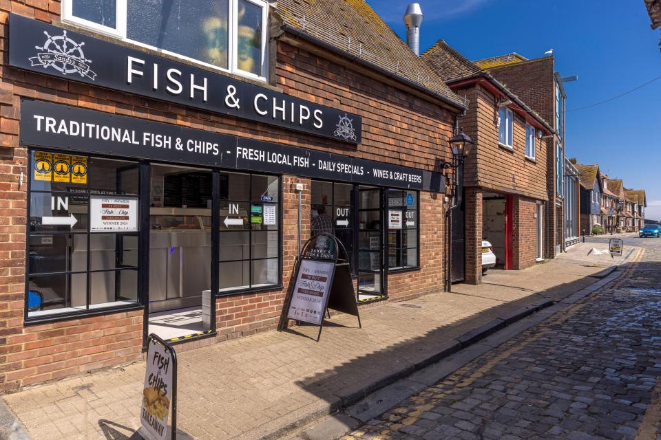 a brick building with a sign that says fish & chips