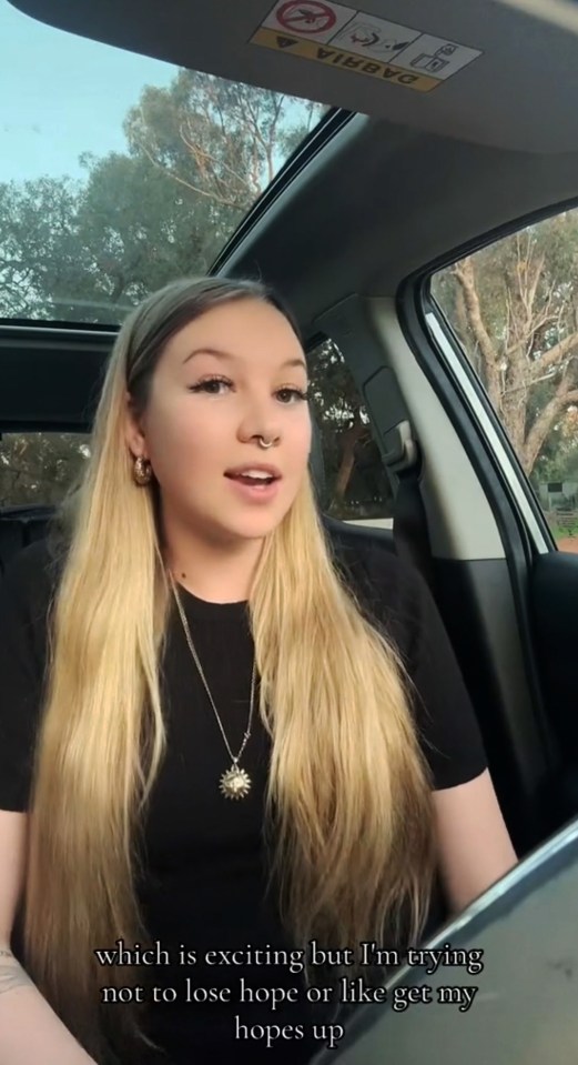 a woman in a car with the word volvo on the visor