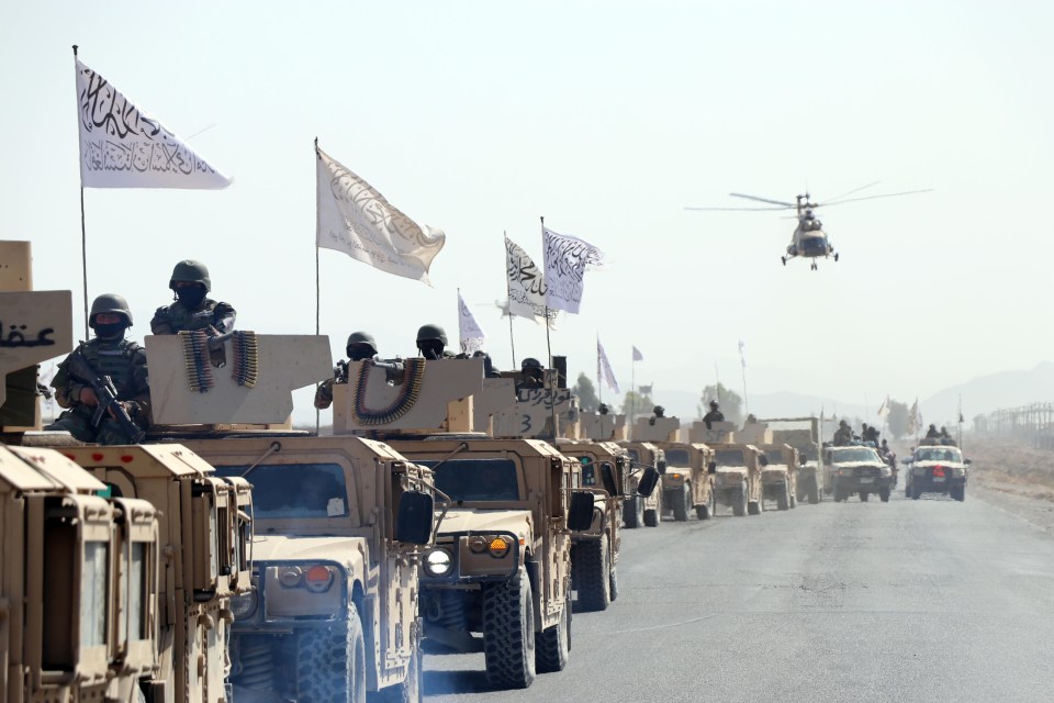 a group of military vehicles are driving down a road