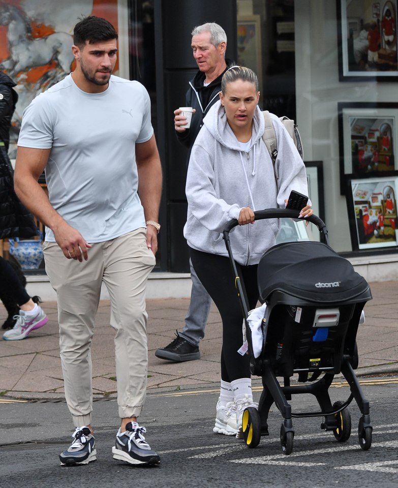 a woman pushing a stroller with the word doona on it