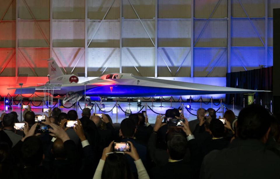 a group of people are taking pictures of a nasa plane
