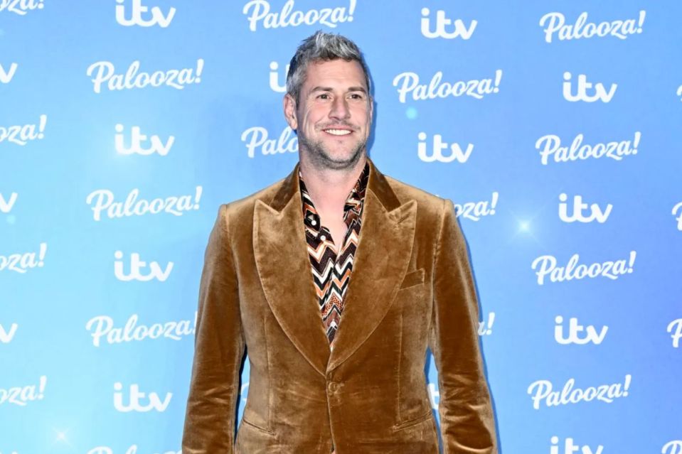 a man stands in front of a wall that says palooza