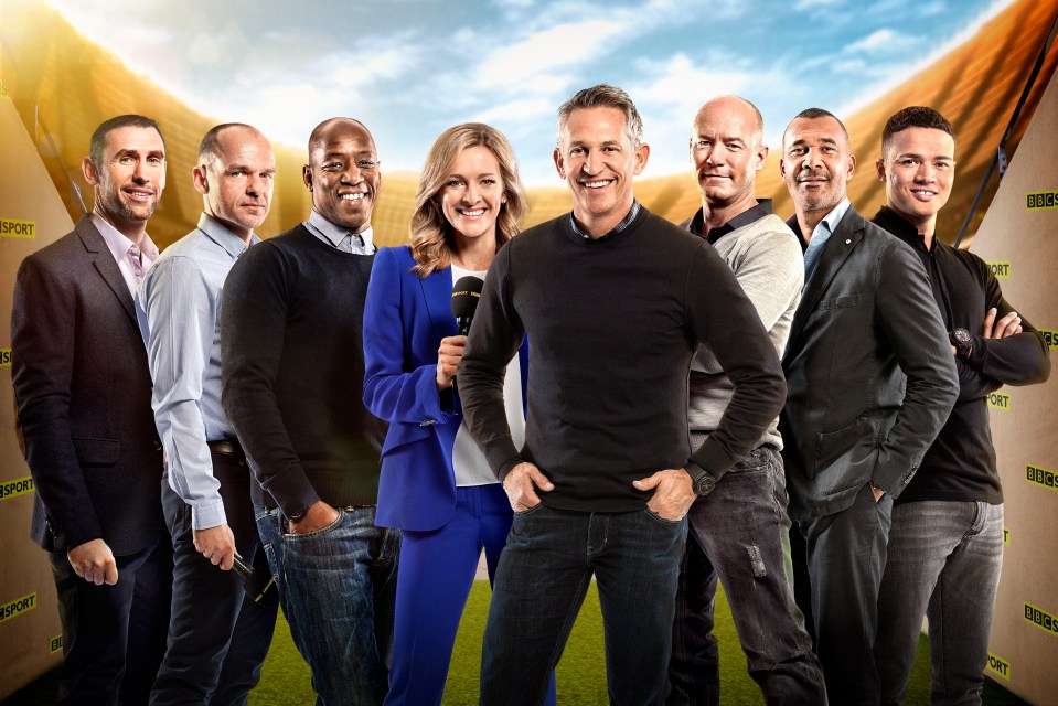 a group of people standing in front of a wall that says bbc sport