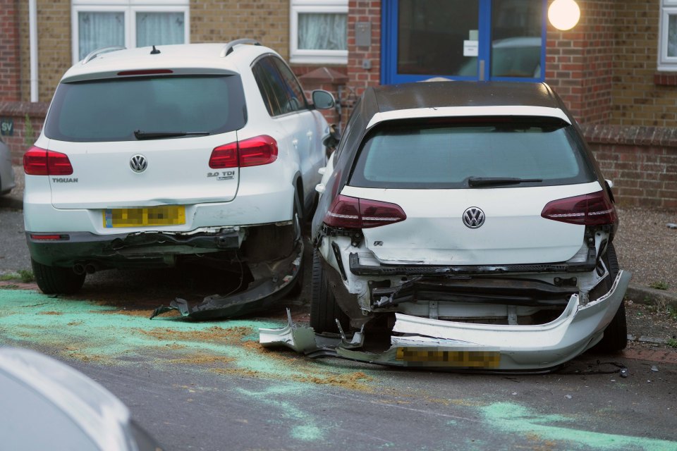 a white volkswagen tiguan is parked next to a black volkswagen