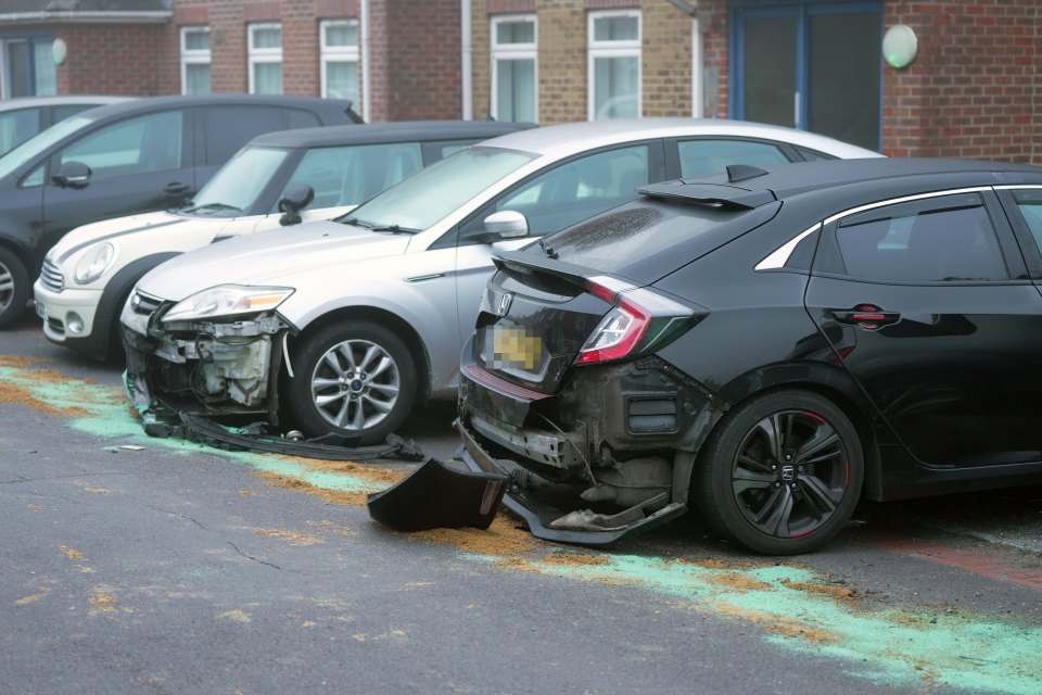 a black honda civic is parked next to a silver car