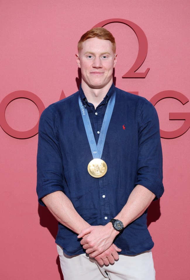 a man wearing a gold medal around his neck