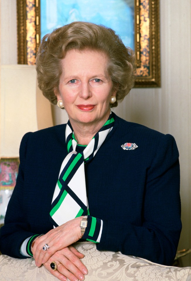 a woman wearing a blue jacket and a green and white scarf