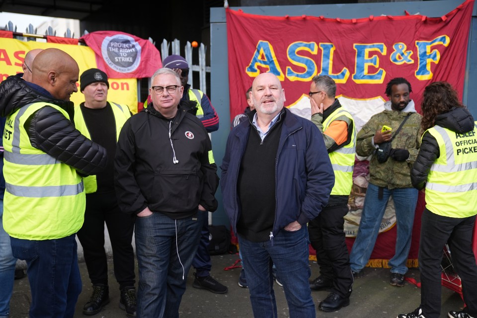 a group of people standing in front of a banner that says ' asleep ' on it