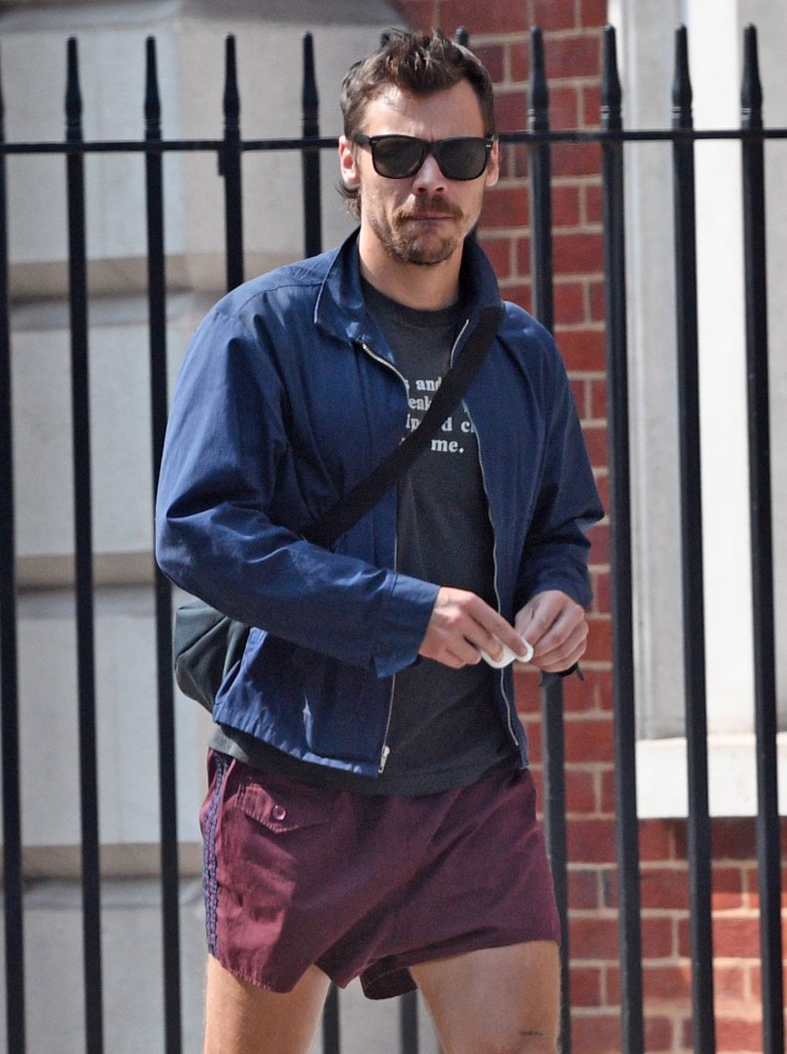 a man wearing sunglasses and shorts has a t-shirt that says " i 'm tired of me "