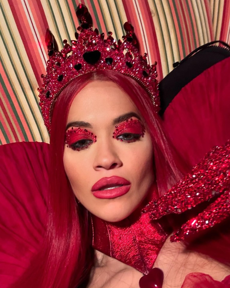 a woman with red hair and a red crown on her head