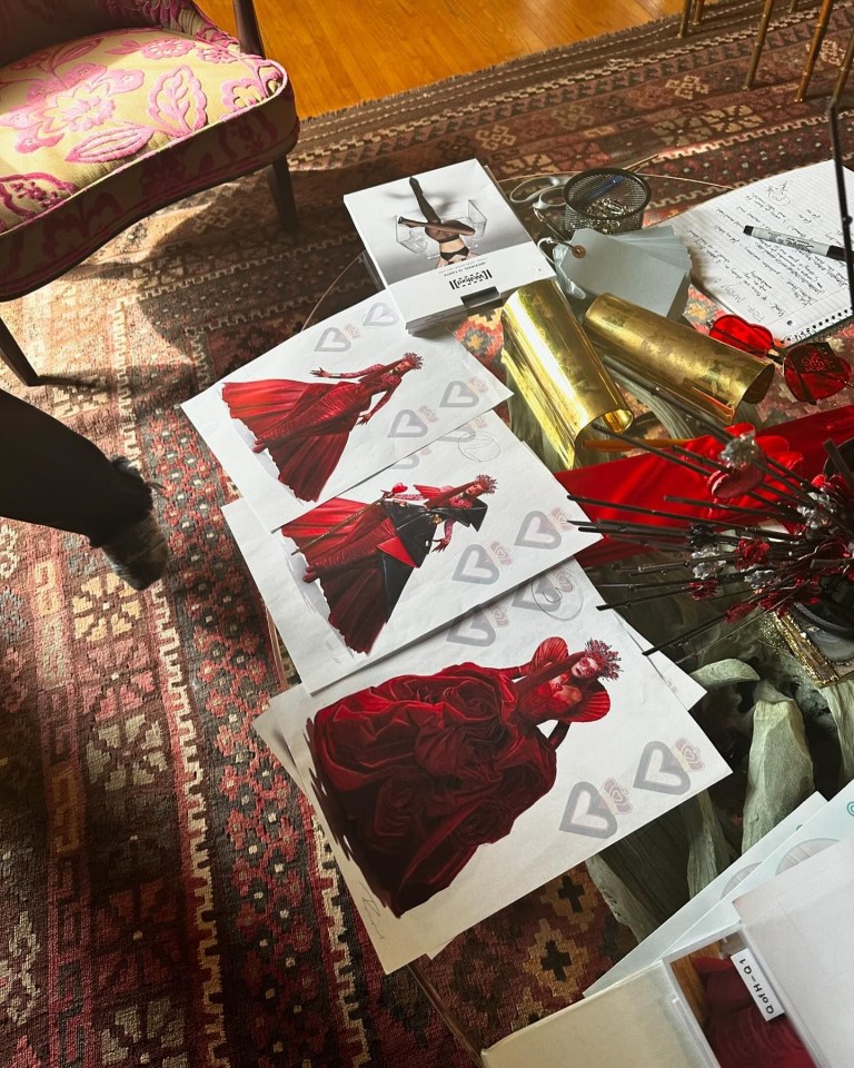 a drawing of a woman in a red dress is on a table