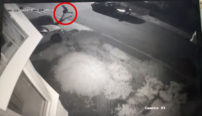 a black and white photo of a person running down a street