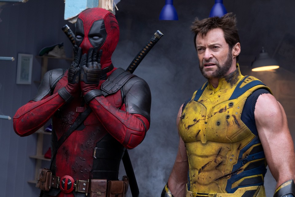 deadpool and wolverine are standing next to each other