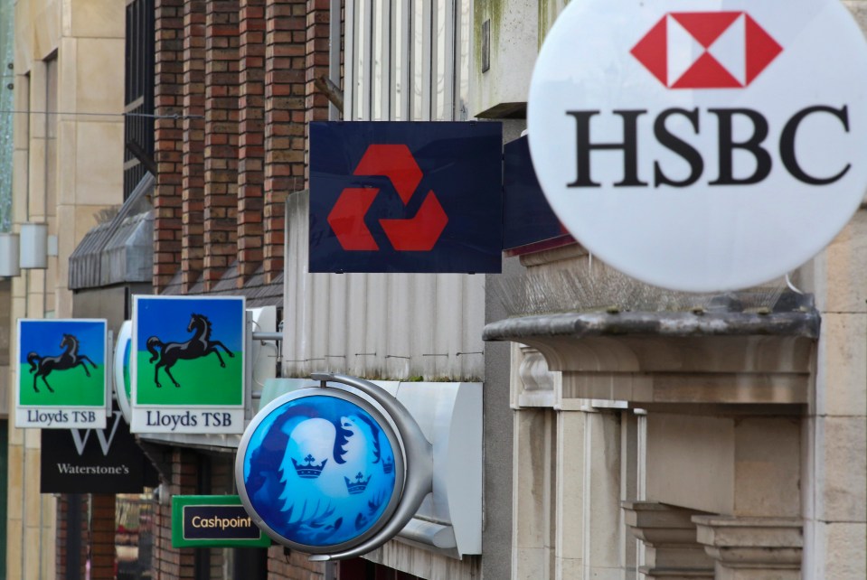 a hsbc sign hangs on the side of a building