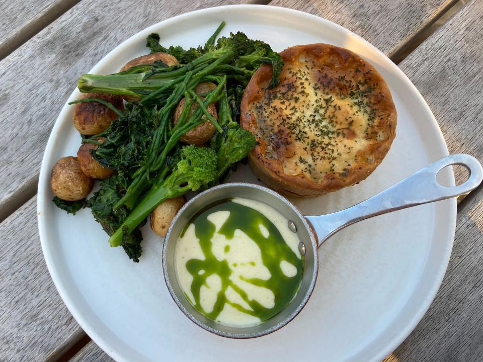 a plate of food with broccoli potatoes and a pie
