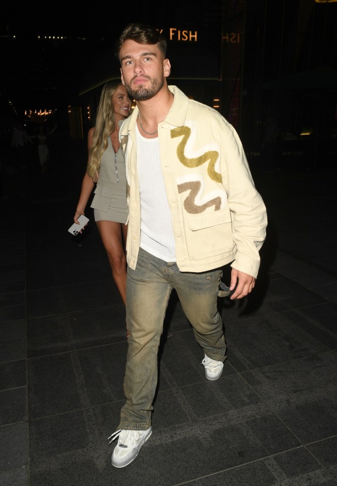 a man wearing a jacket with the letter n on it