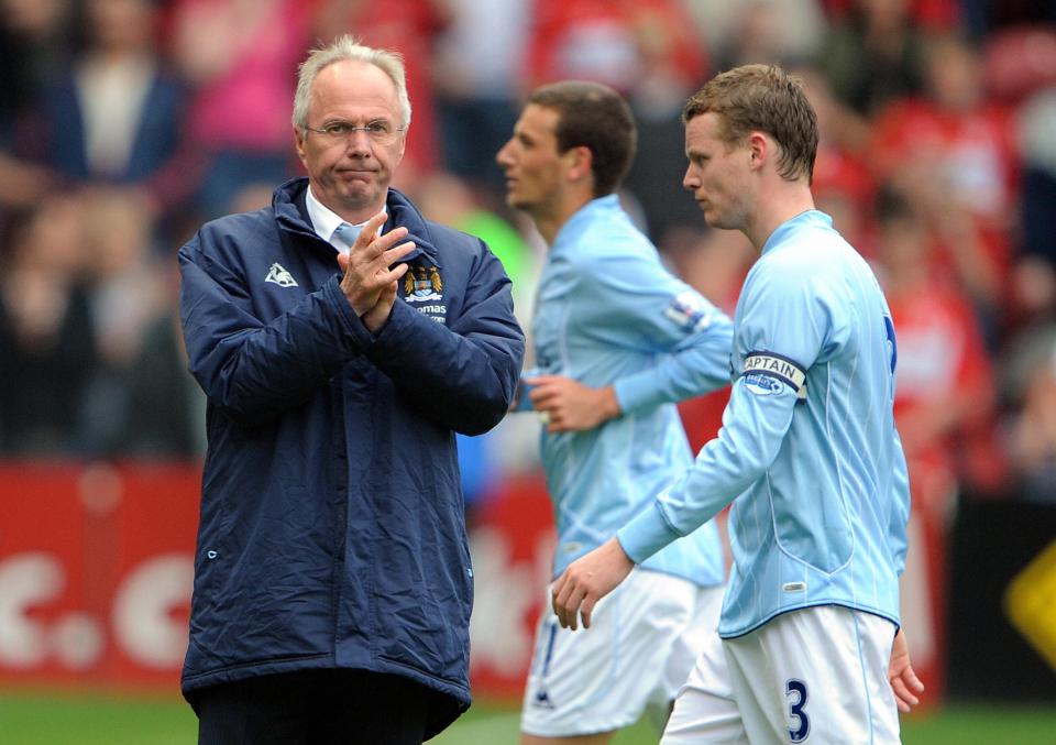 a man in a blue jacket with the word manchester on it