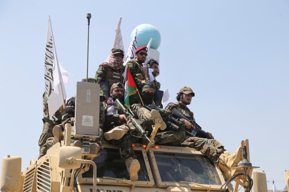 a group of soldiers sitting on top of a military vehicle with a flag that says ' afghanistan ' on it
