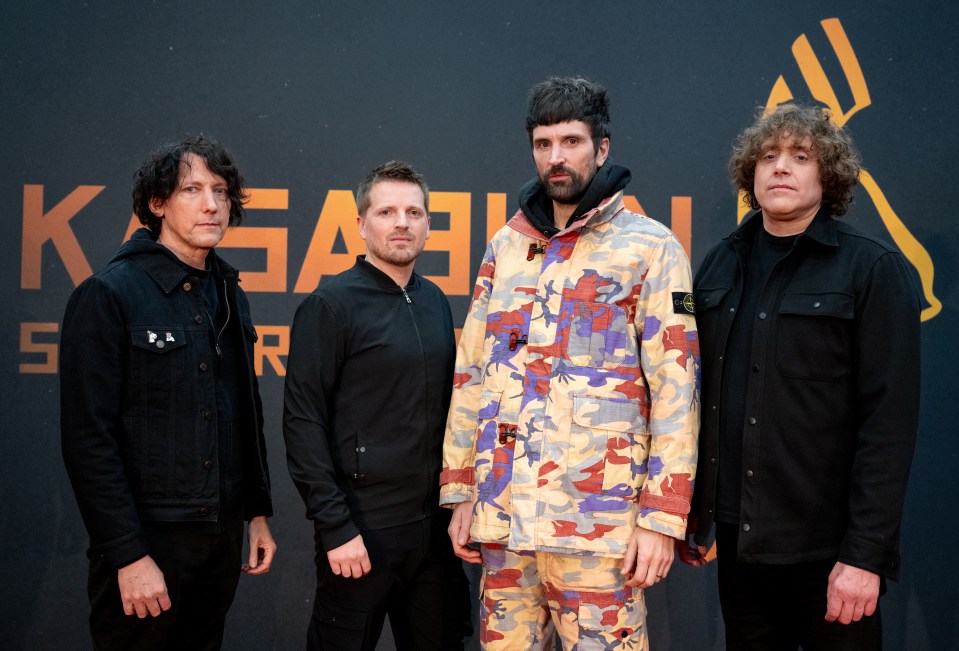 four men standing in front of a sign that says kasai
