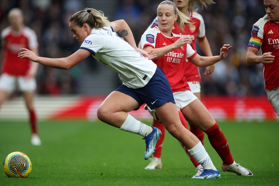 a female soccer player wearing a fly emirates jersey