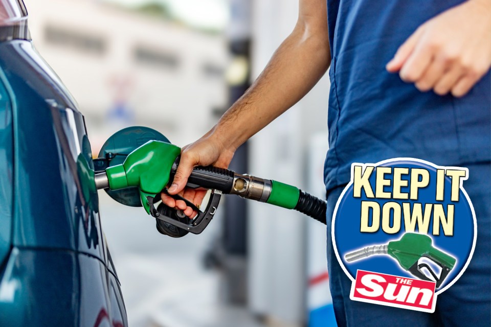 a man pumping gas into a car with a sticker that says keep it down