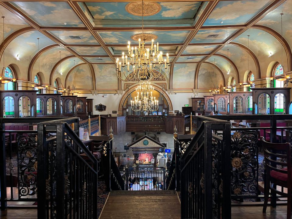 the inside of a building with a chandelier hanging from the ceiling