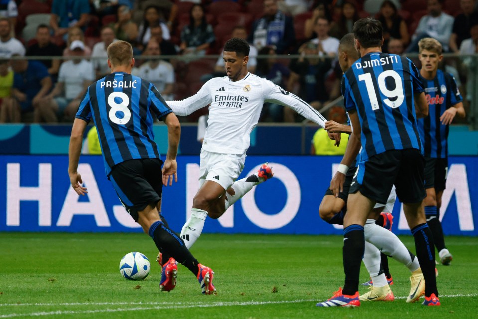 a soccer player wearing a jersey that says emirates fly better