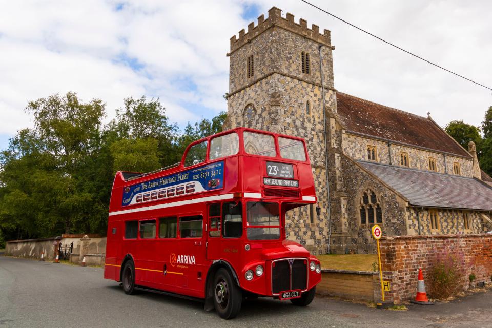 a red double decker bus with the number 23 on it