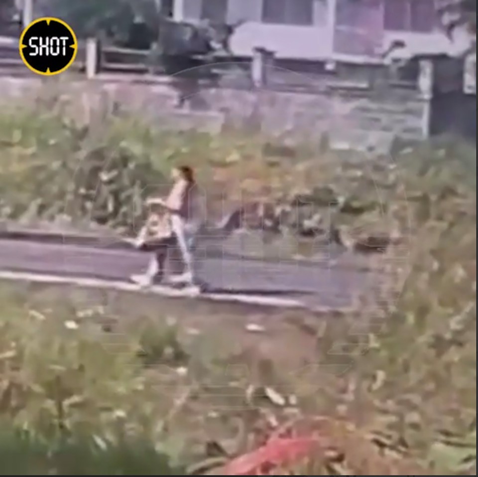 a shot of a person walking down a street