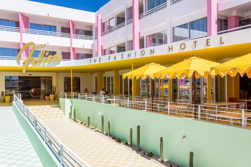 the front of the fashion hotel with yellow umbrellas