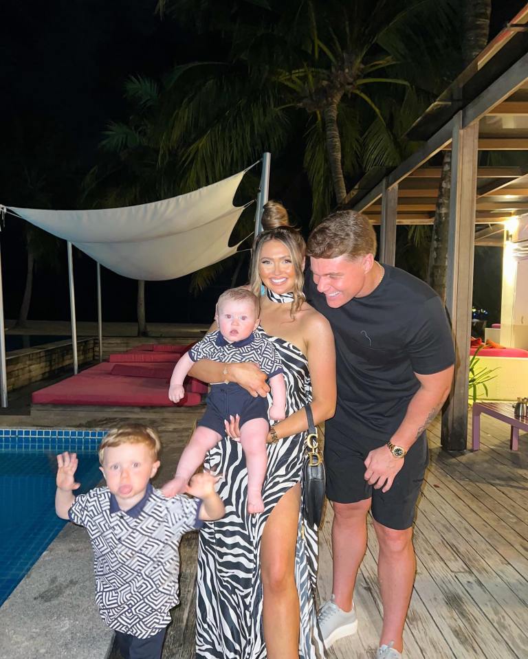 a family posing for a picture in front of a pool