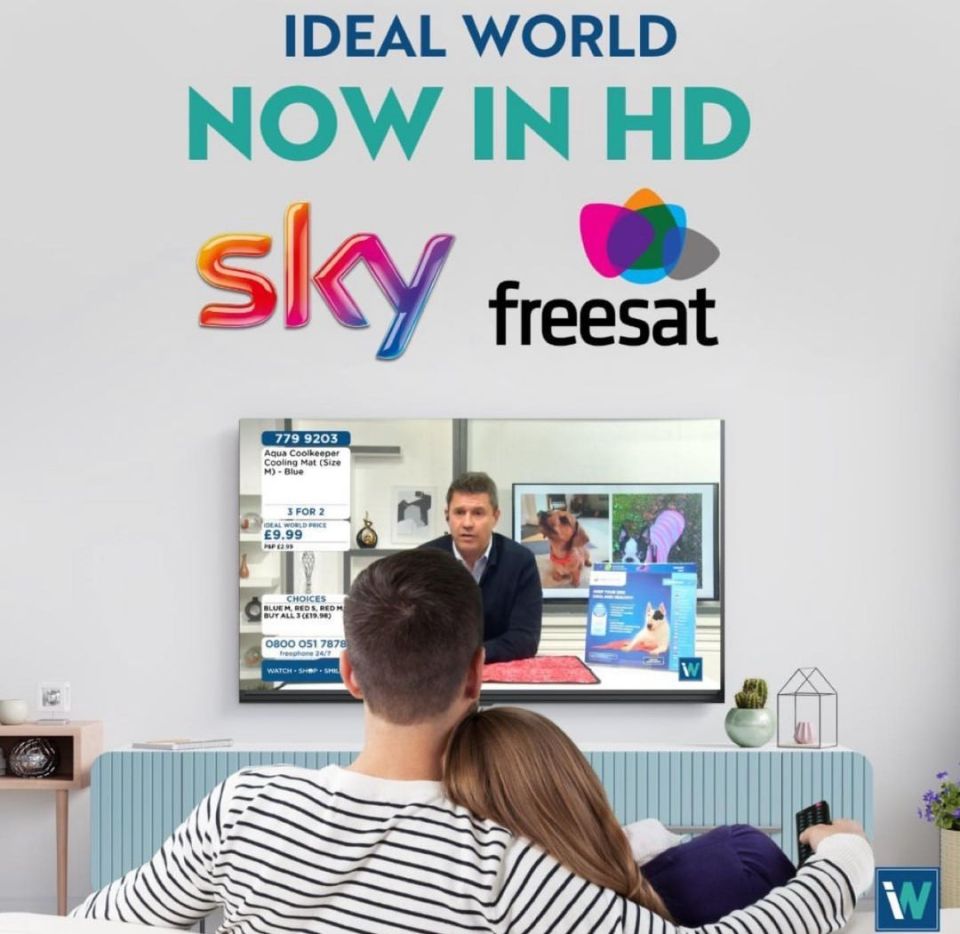 a couple sitting on a couch watching a sky freesat channel