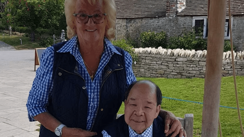 a woman standing next to a man with his arm around his shoulder