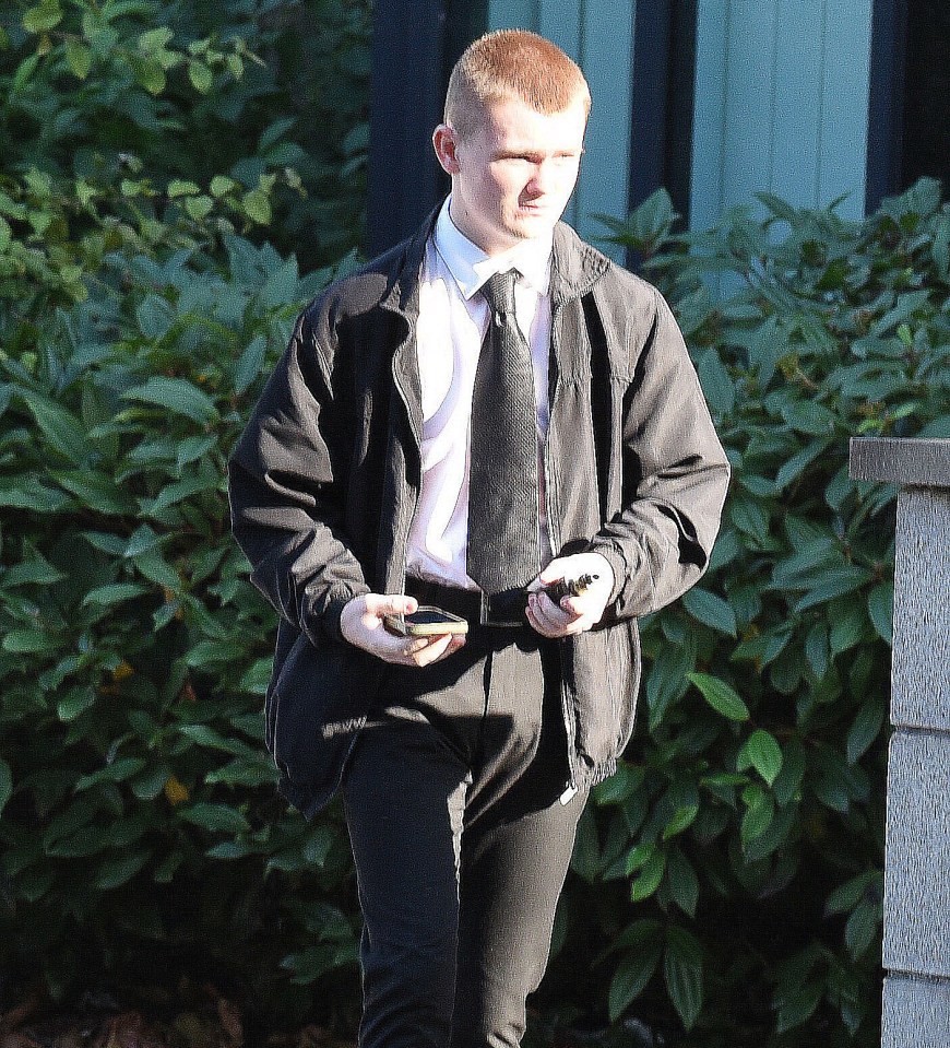 a man in a suit and tie is walking down a sidewalk