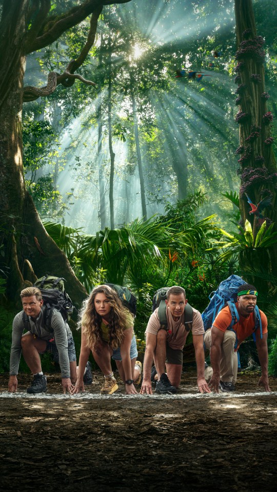 a group of people with backpacks are kneeling down in a jungle