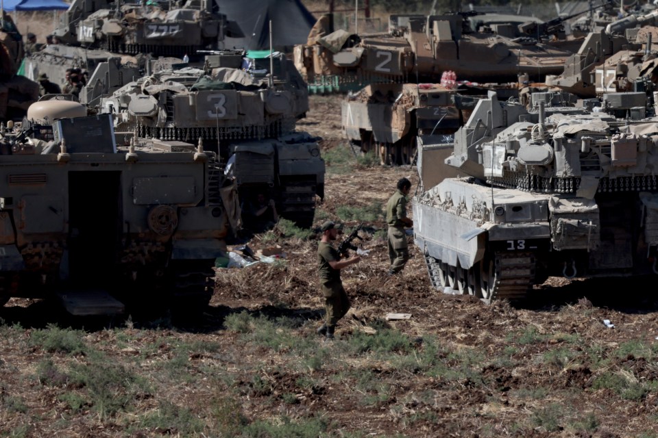 a row of military vehicles including one with the number 13 on it