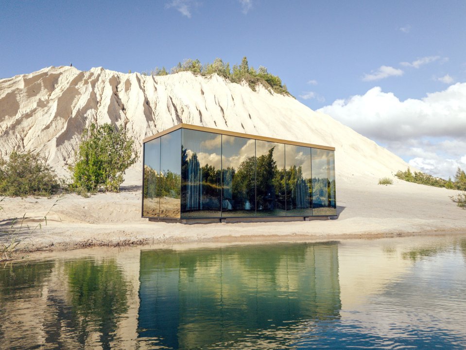 a reflection of a building in a body of water