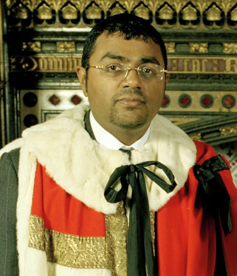 a man in a robe with the letter r on it