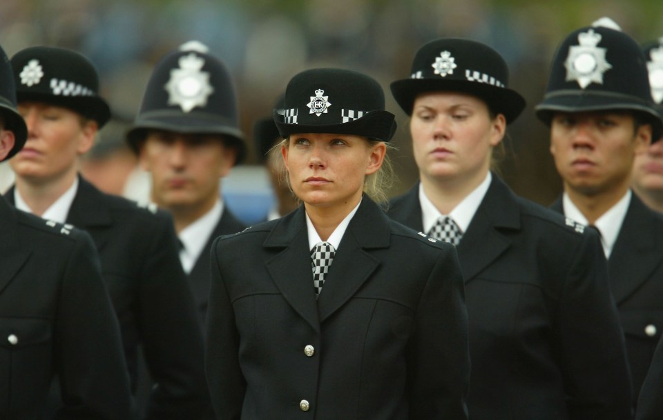 a group of police officers are lined up in a line