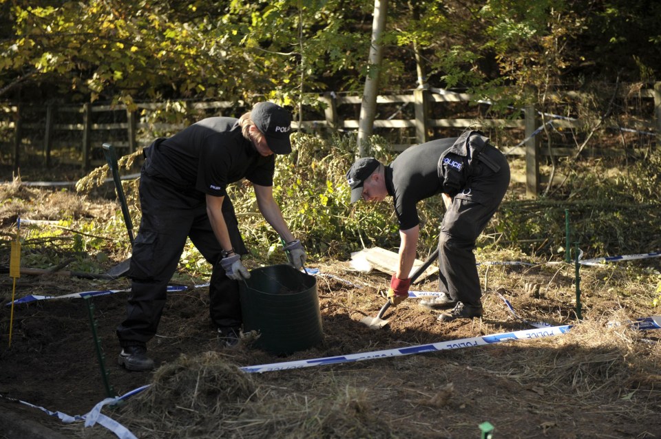 two police officers are digging in a field