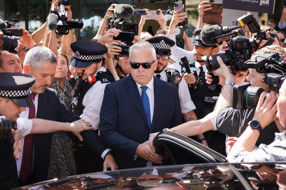 a man in a suit and tie is surrounded by police officers