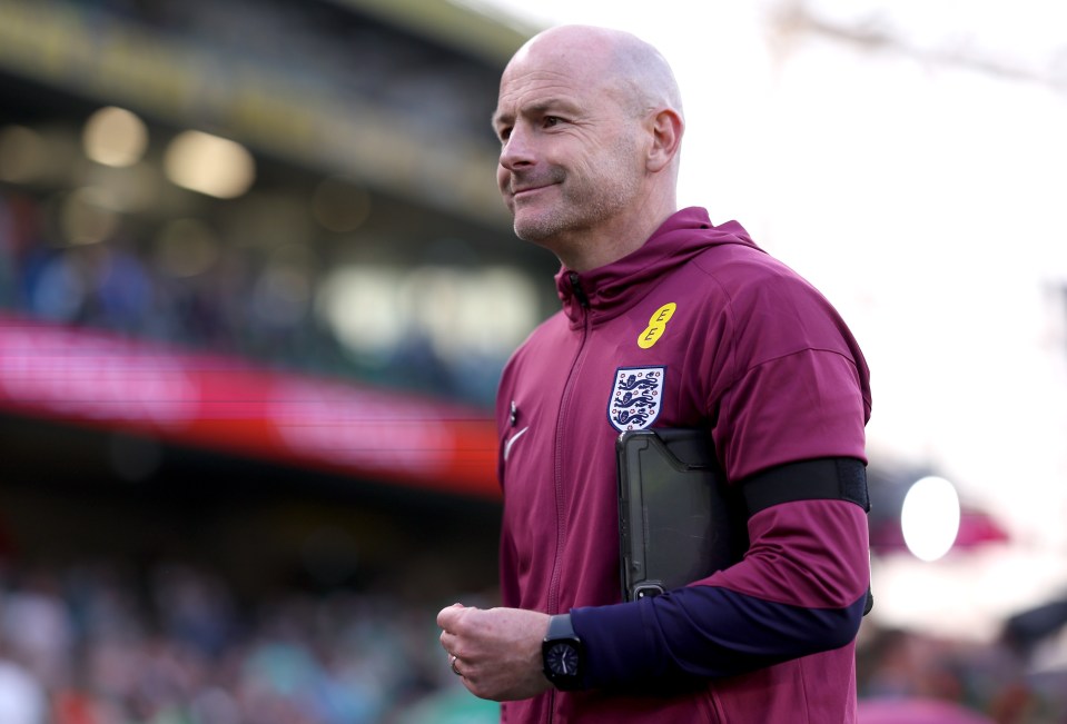 a man wearing a maroon jacket with the word eee on it