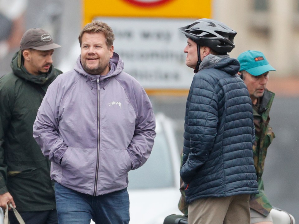a man wearing a jacket that says stussy on it