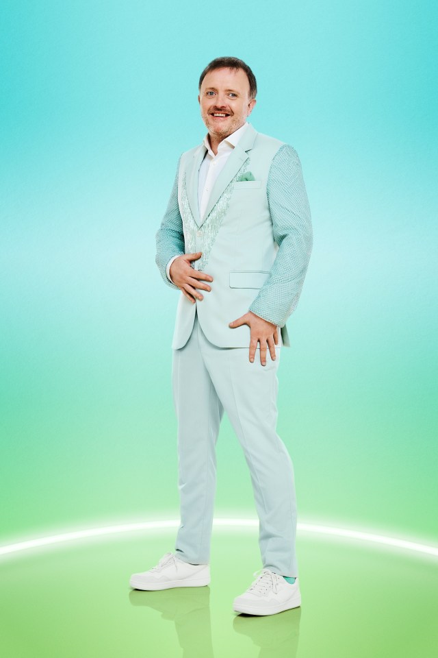 a man in a light blue suit and white sneakers