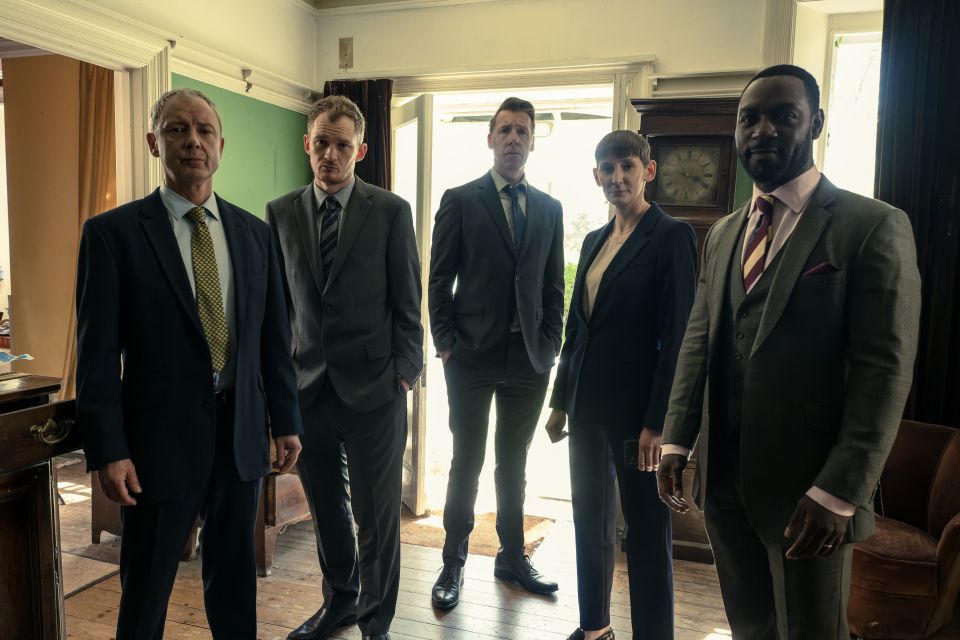 a group of men in suits and ties are standing next to each other