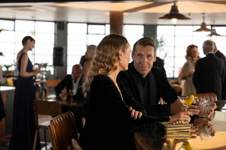 a man and woman are sitting at a bar talking