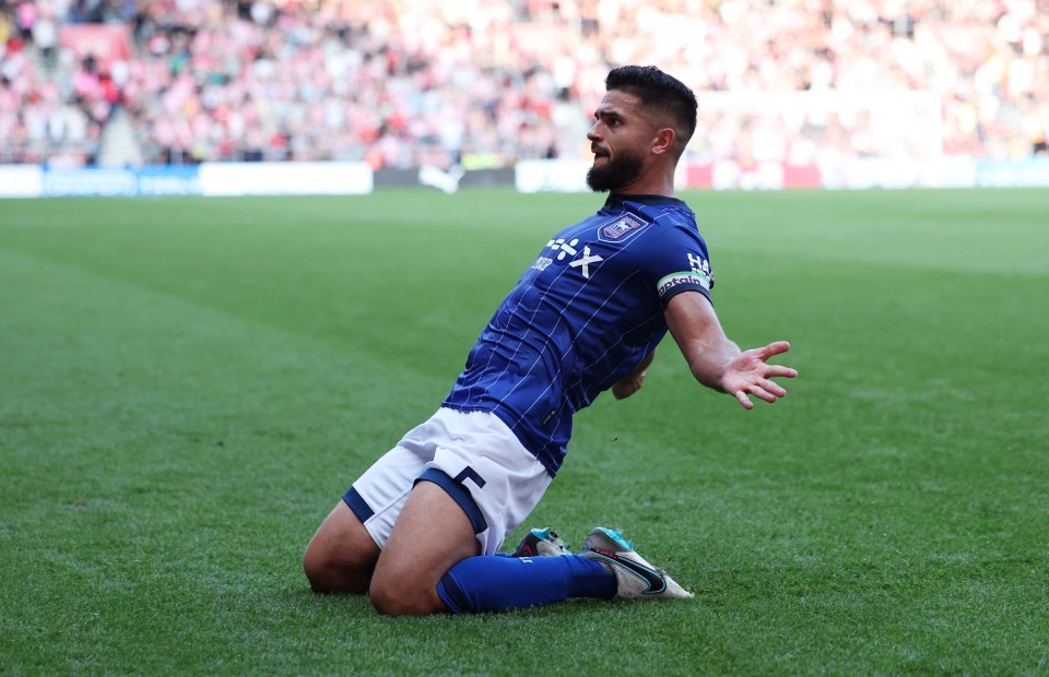 a soccer player in a blue shirt with a x on it
