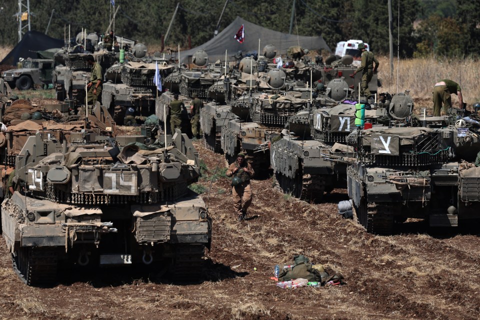 a row of military vehicles including one with the number 14 on it