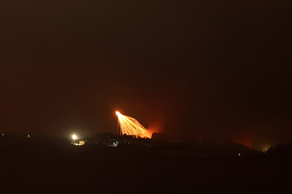 a fireworks display is lit up in the night sky