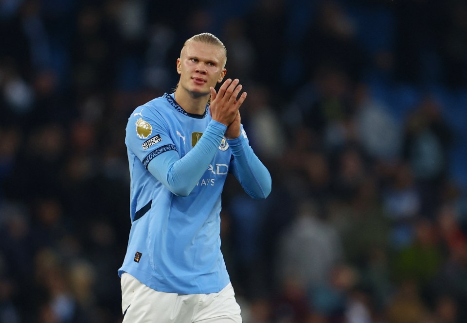 a soccer player wearing a light blue shirt with the word ad on it